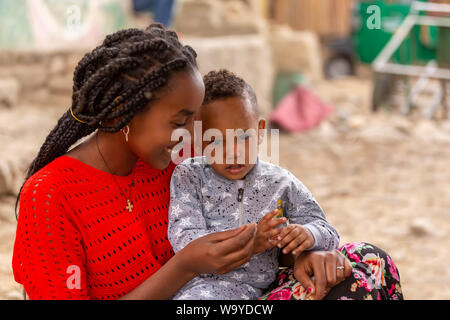 Inticho, Tigray Region, Ethiopia - April 28, 2019: Ethiopian beautiful local women with son on the street of Inticho city, Ethiopia, Africa Stock Photo