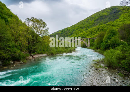 Montenegro, Green forest area covering high mountains connected by bridge surrounding turquoise waters of moraca river in moraca canyon Stock Photo