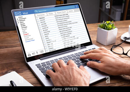 Close-up Of Man Checking Mail Inbox On Laptop Stock Photo