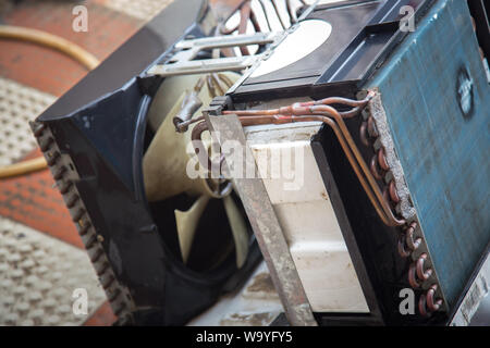 Worker cleaning window air conditioner by water for clean a dust on it in customer home when maintenance service. Breath, repair. Stock Photo