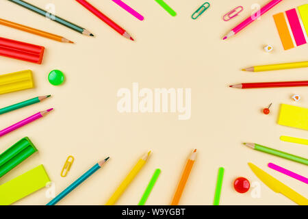 Back to school creative template with pencils, clips and writing materials. Composition in green, yellow and red colors. Stock Photo