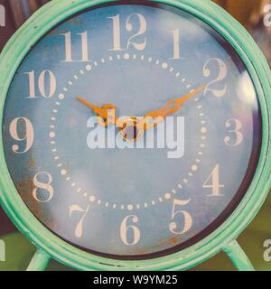 Round teal and white analog table clock displaying 10:10 time Stock Photo