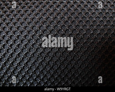 Black textile furniture upholstery mesh. Background textured seamless pattern. Stock Photo