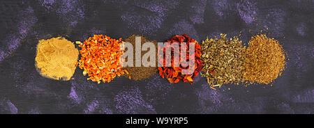 Different spices on dark background. Top view. Banner. Stock Photo