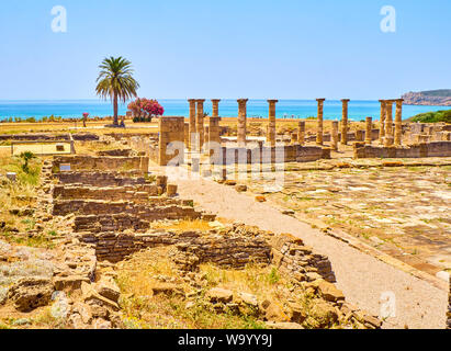 Remains of the Forum with the Tabernae in the foreground and the Basilica in the background. Baelo Claudia Archaeological Site. Tarifa, Cadiz. Spain. Stock Photo