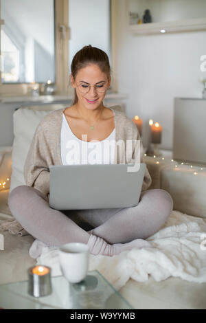 beautiful happy woman with blond hair surfing the net/homeoffice Stock Photo