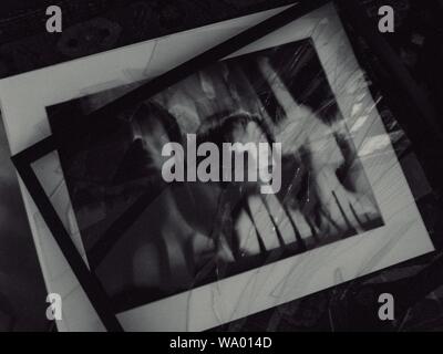 Grayscale shot of shattered glass picture frame Stock Photo