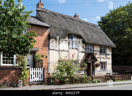 The Stag's Head pub, a thatched and half timbered building in the heart of the village. Stock Photo