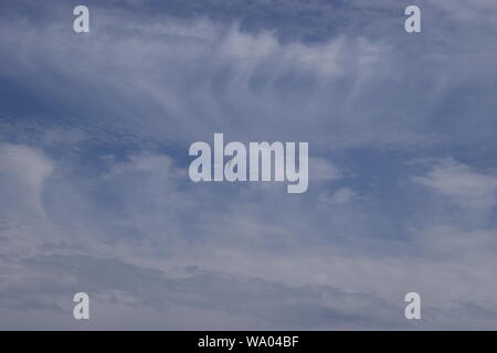 Beautiful white fluffy cloud formations on a deep blue sky Stock Photo