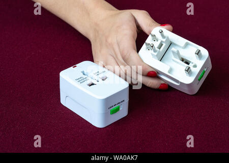Close up of universal electric socket plug adapters used for travel. Used to connect to different electrical outlets worldwide. Electric adapter isola Stock Photo