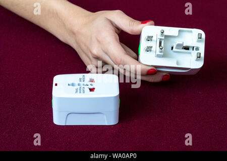 Close up of universal electric socket plug adapters used for travel. Used to connect to different electrical outlets worldwide. Electric adapter isola Stock Photo