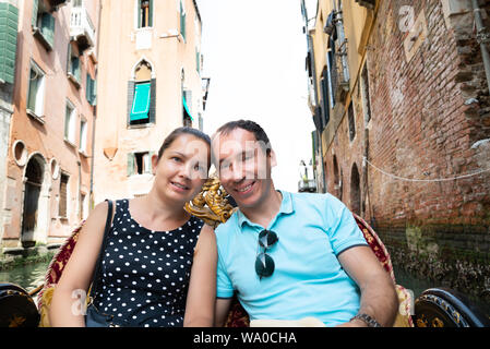 Young Couple Riding In Gondola, Venice, Italy Stock Photo