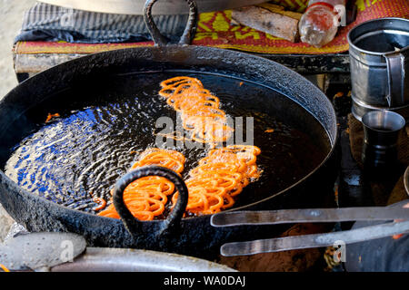 Close up of traditional Pakistani sweet called Jalebi or Zulbia is a round coil shipped juicy sweet Stock Photo