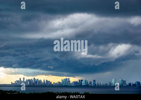 Miami Beach Florida,dark clouds weather sky storm clouds gathering,rain,city skyline,Biscayne Bay,FL190731008 Stock Photo