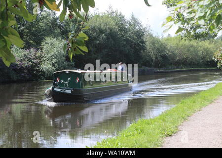 Narrow boat cruising along the Aire and Calder Navigation, a canal in Knottingley West Yorkshire in Britain,UK