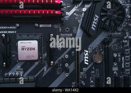 Valencia, Spain - August 12, 2019: AMD Ryzen 3700x processor in the X570 motherboard socket. New Zen 2, 7 nanometer desktop CPU by AMD. Very popular 3 Stock Photo