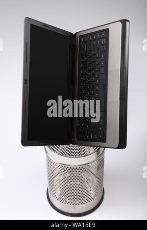 Laptop in garbage can Stock Photo