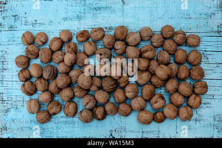 Walnuts on an old wooden background of blue color. Selective focus. Stock Photo
