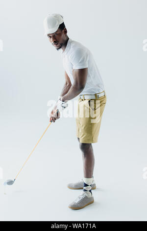 handsome african american sportsman playing golf on grey background Stock Photo