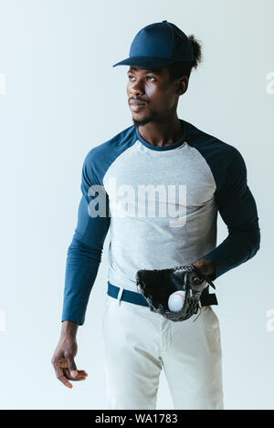 confident african american baseball player looking away isolated on grey Stock Photo