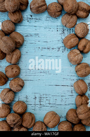 Walnuts on an old wooden background of blue color. Selective focus. Stock Photo