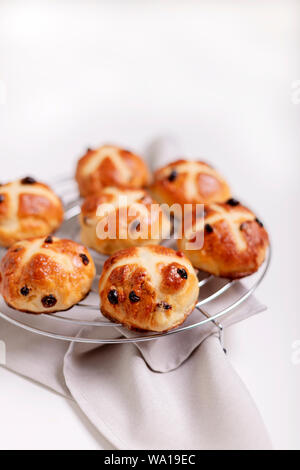 Buns marked with a cross and containing dried fruit, traditionally eaten during Lent. Selective focus. Stock Photo