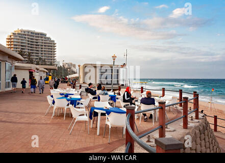 DURBAN, SOUTH AFRICA - AUGUST 12, 2019: Tourists enjoying lunch at a restaurant on the promenade at the beach in Umhlanga Rocks, near Durban, KwaZulu- Stock Photo