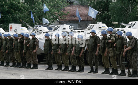 9th May 1993 During the Siege of Sarajevo: Ukrainian soldiers stand in line in the parade ground of Tito Barracks, next to their BTR-80 APCs. As part of the United Nations Protection Force (UNPROFOR), they are about to depart to offer protection to the Bosnian Muslim enclave of Žepa, 40 kilometres east of Sarajevo. Stock Photo