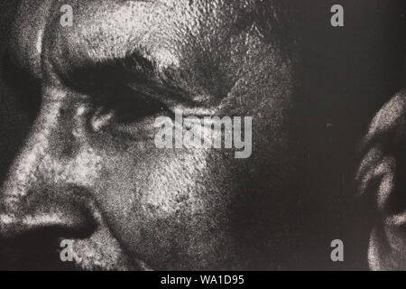 Fine black and white art photography from the 1970s of a man suspicious of what he's seeing. Stock Photo