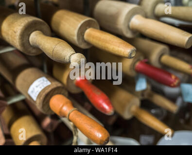 A selection of various wooden old rolling pins for sale in a second hand shop. Stock Photo