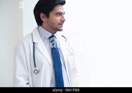 Doctor with stethoscope, looking away. Stock Photo