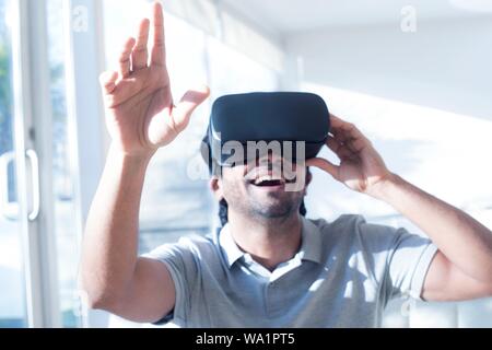 Man wearing virtual reality (VR) headset. Stock Photo