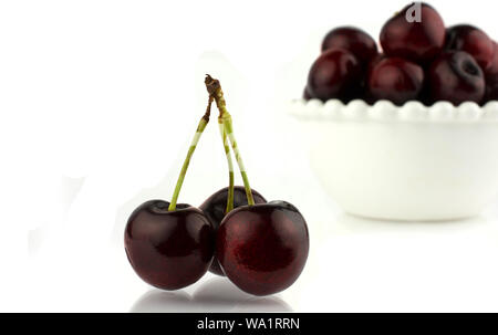 close-up some cherries with stems. Isolated on white background. Stock Photo
