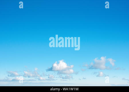 fleecy clouds on an azure sky. beautiful nature background. dynamic side lit cloudscape Stock Photo