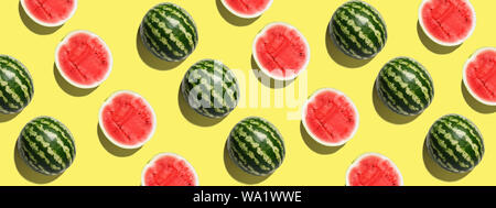Pattern with ripe watermelon on yellow background. Pop art design, creative summer concept Stock Photo