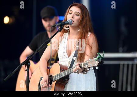 AUG 15, 2019 : Cassidy Daniels performs as the warmup act to Billy Currington during a summer concert held at The Freeman Stage in Selbyville, DE. Stock Photo