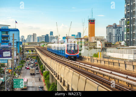 Bangkok - June 25, 2019: a train arrives in On Nut BTS station, with Sukhumvit Road beneath. Stock Photo