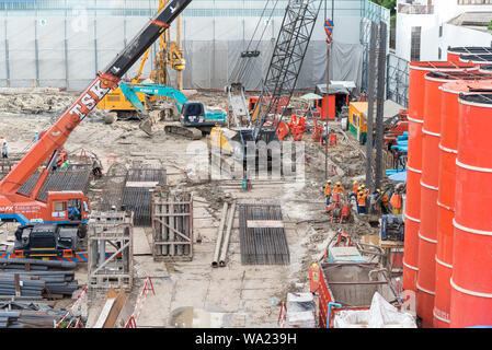 Bangkok, Thailand - June 25, 2019: machines & workers in SEAFCO uniform work on construction site of O-Nes Tower. Stock Photo