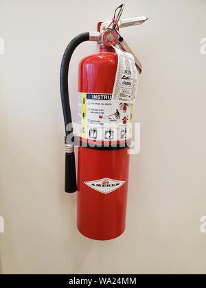 A fire extinguisher in a wall mounted storage box Stock Photo - Alamy