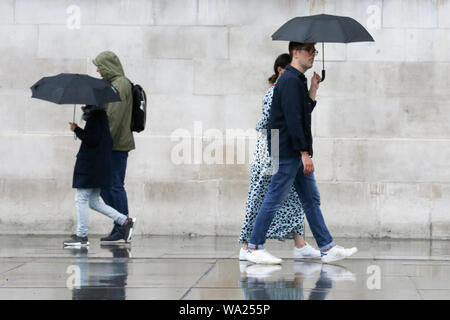 London, UK. 16th Aug, 2019. People are seen beneath umbrellas during rain in London. Credit: Steve Taylor/SOPA Images/ZUMA Wire/Alamy Live News Stock Photo