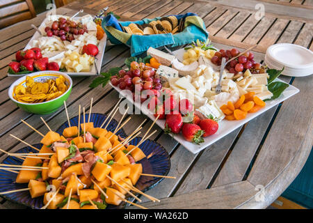 Fruit and cheese platters on a table at a picnic. Stock Photo