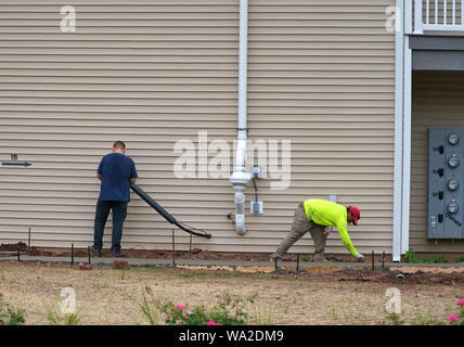 Middletown, CT USA. Aug 2019. A utility technician and construction worker giving this newly constructed apartment the finishing touches. Stock Photo