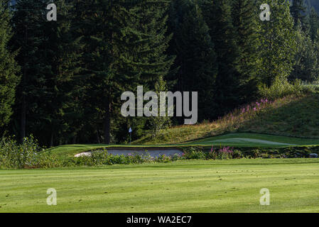 WHISTLER, BC/CANADA – AUGUST 3, 2019: Fairmont Chateau Whistler Golf Club morning fairway and green. Stock Photo