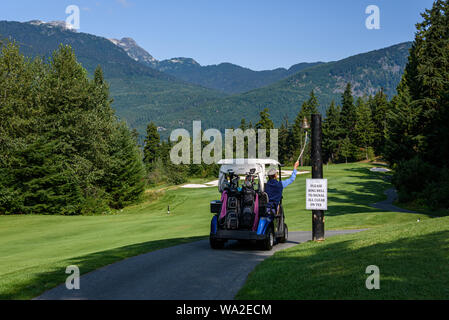 WHISTLER, BC/CANADA – AUGUST 3, 2019: Fairmont Chateau Whistler Golf Club, unknown man ringing signal bell on a sunny day. Stock Photo