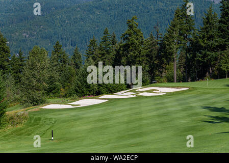 WHISTLER, BC/CANADA – AUGUST 3, 2019: Fairmont Chateau Whistler Golf Club, sunny day with fairway, sand traps, and green. Stock Photo