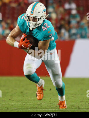 Miami Dolphins running back Patrick Cobbs (38) picks up 30 yards on this  catch against the Baltimore Ravens in first quarter action in the NFL AFC  wildcard game at Dolphin Stadium in