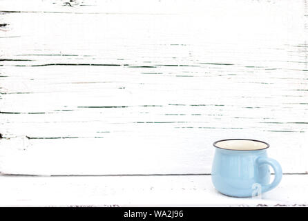 Enameled mugs in retro style on an old wooden background. Selective focus. Stock Photo