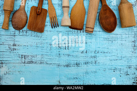 Vintage old kitchen utensils on a blue wooden background. Selective focus. Stock Photo