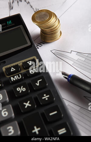 Calculator with coins and bar graph Stock Photo