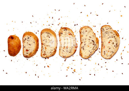 Top view from above composition of set sliced homemade wheat grain fresh gluten free bread, crumbs decorated flax seeds, space for text isolated on wh Stock Photo